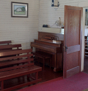 old upright piano in the corner of an old church